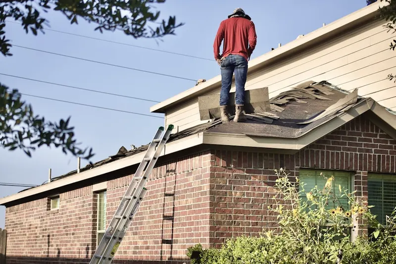 Professional roofer working on a residential roof in Amberwood at Bayside Lakes